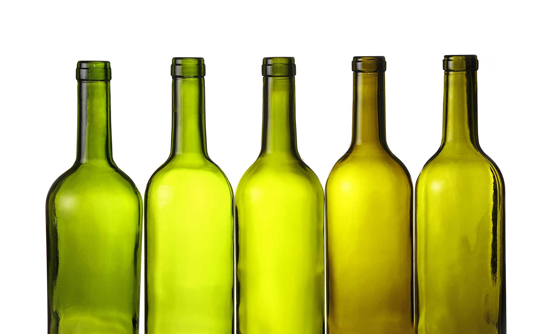 Rows of antique green wine bottles against a white background